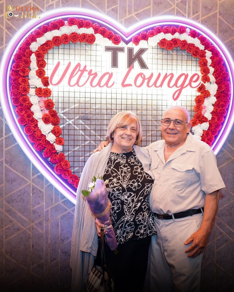 Couple clicking photos with tk ultra lounge banner