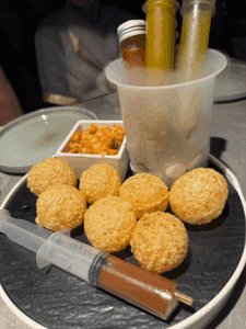 Pani puri with their Sauce in injection tube